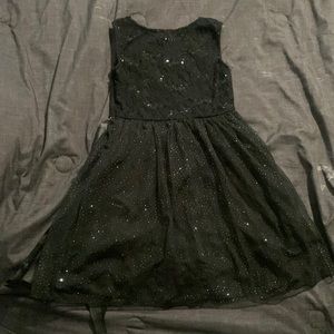 Sparkly black kids dress with a silky ribbon on the back